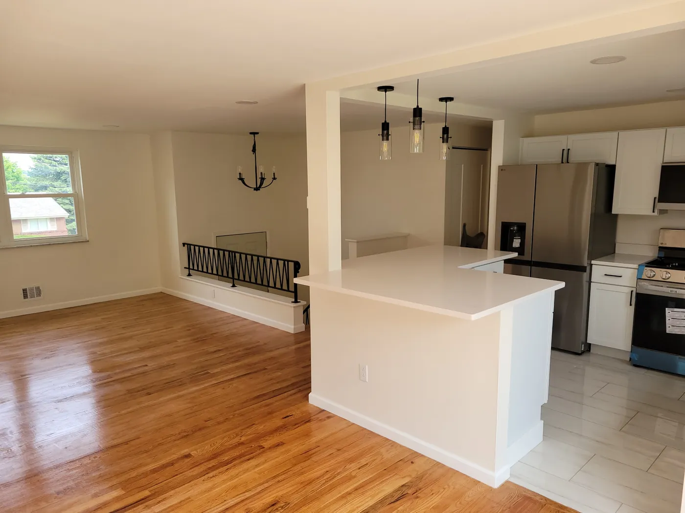Kitchen island and fresh painted walls beside a refinished floor